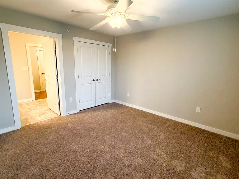 The bedroom is attached to the bathroom and provides a large double door closet.