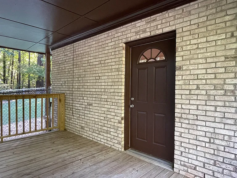 Front door and front deck off the private driveway.