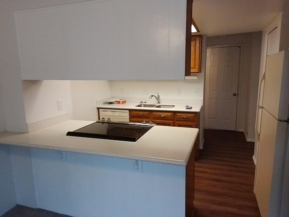 Solid surface counter tops. New laminate flooring. New solid surface stainless steel range with black top.