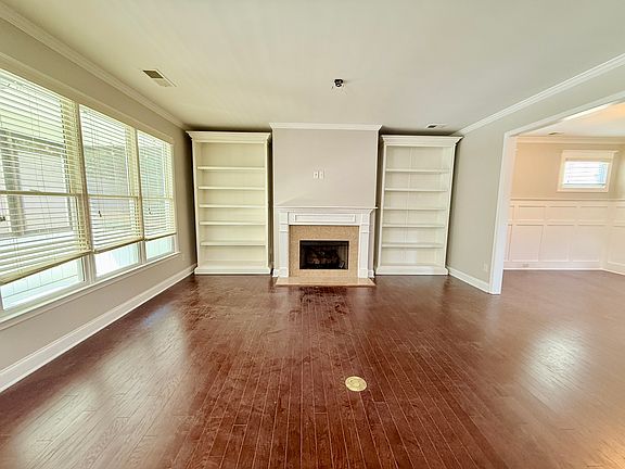 Living room with gas fireplace and storage shelves