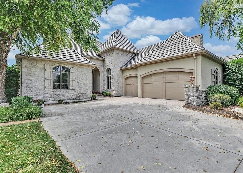 More of the extensive stone detail at entry, concrete tile roof, 3 car garage, an ample drive for easy in/out of garage and a truly beautiful setting.