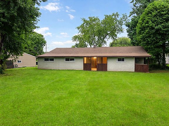 Rear exterior - single story ranch on large level lot with mature trees and open space