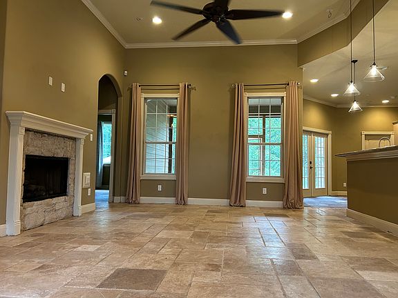 living room view when opening the front door looking out onto the screened room and backyard