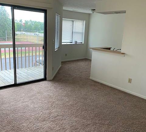 Looking from entry into 2196 E- sliding glass doors on to balcony, dining room area and kitchen