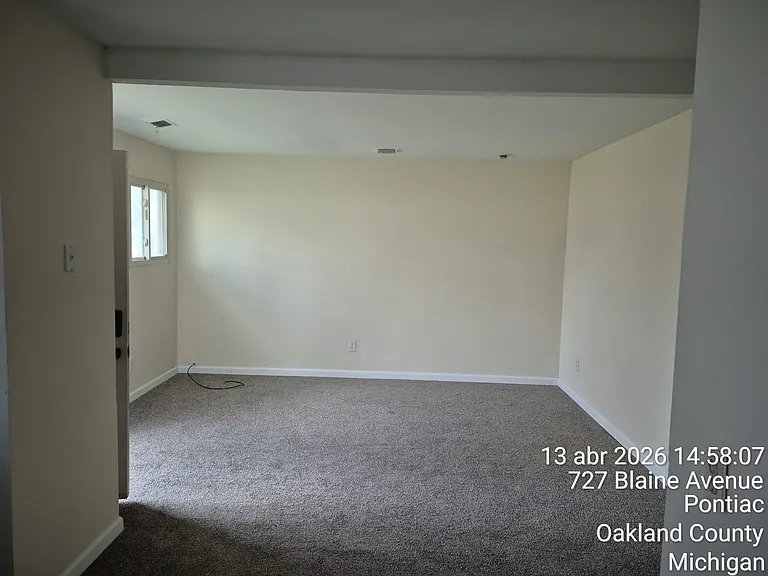 LIVING ROOM: a living area that is ready for your decorative imagination. Brand new carpet and newly painted interior.