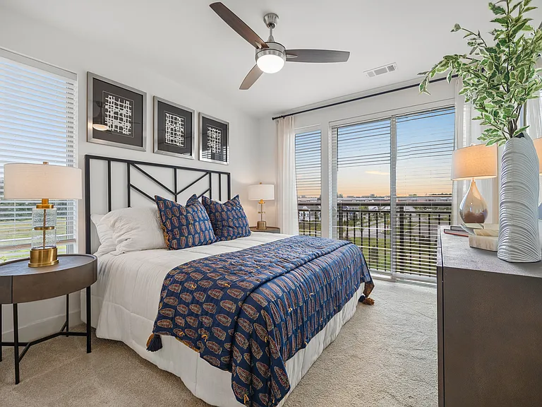 Spacious bedroom with floor to ceiling windows to maximize light