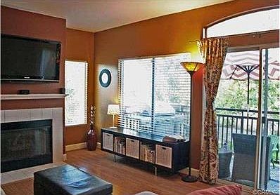 Living room with gas fireplace. Windows pleasantly facing views