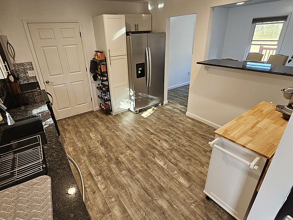 Kitchen facing laundry room door.