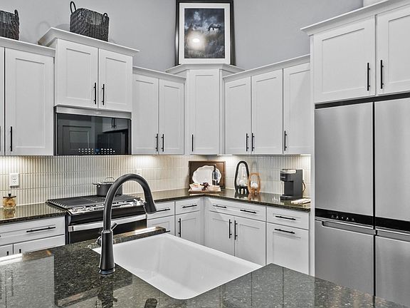 Modern kitchen with streamlined island for easy prep, storage, and gathering