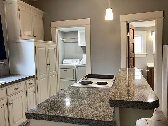 Kitchen - large island with laundry room and bathroom access