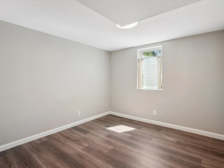 This Bedroom Has Full Egress + a Separate Door to the Basement Bathroom for an En-Suite Feel