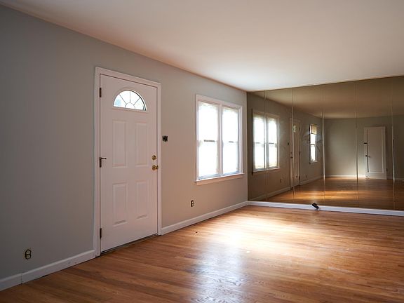 Spacious front room with fresh paint and polished wood floor