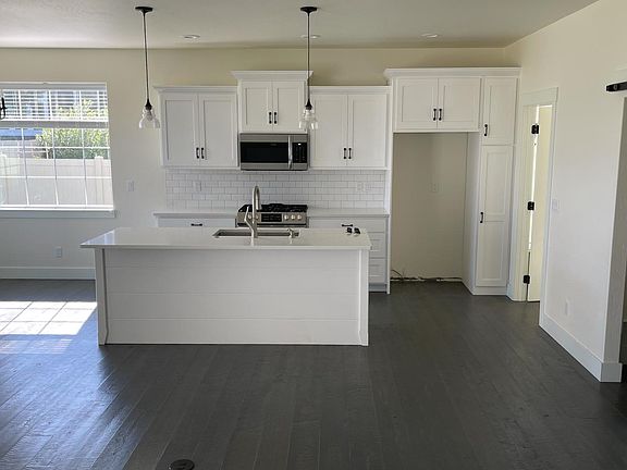 Kitchen with dining area on the left and living room in front. Laundry room off the kitchen to the right. Walk in pantry sliding barn door on the right.