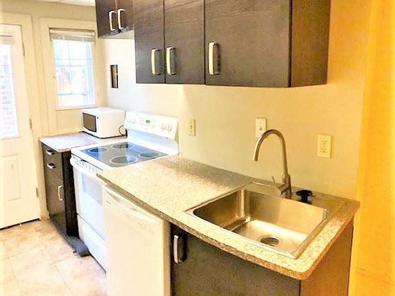 Kitchenette with gorgeous cabinets and lots of storage space