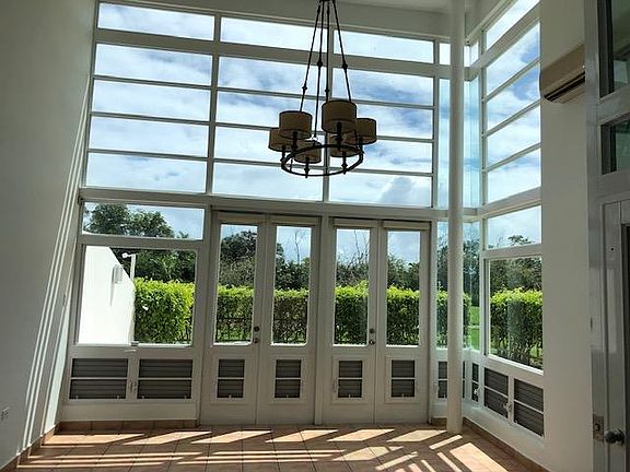 Living room opens to garden, greenbelt and small lake