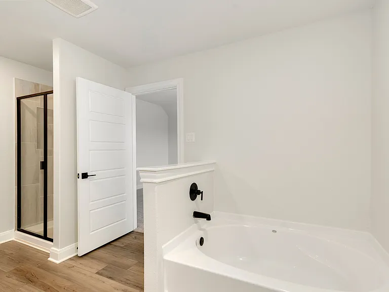 A tub and separate step-in shower in the master bathroom.