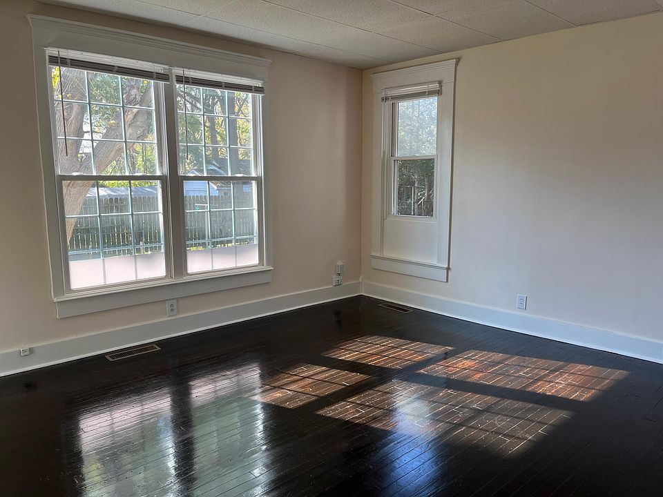Inside your giant master suite with gleaming original hardwood floors, here is the spot for your desk. Look out over your lawn with beautiful trees.