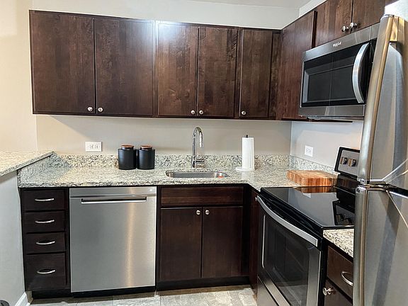 New kitchen with stainless appliances, including dishwasher and microwave