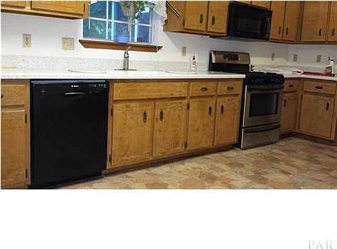 Large upgraded kitchen has solid countertops with undermount sink
