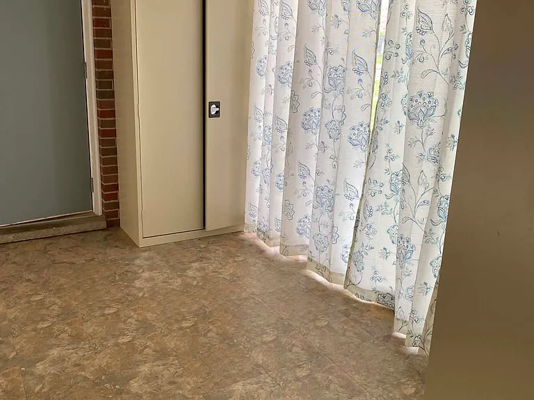 Breezeway room wit three metal storage cabinets