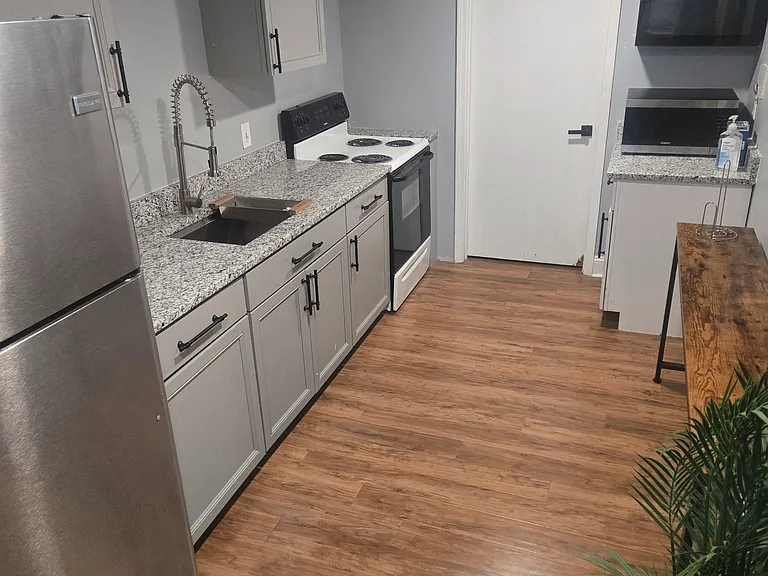 Efficient kitchen with ample cabinet storage, granite-look counters, and stainless appliances for everyday cooking.