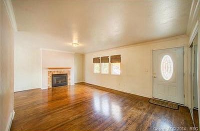 The living room with crown molding, and the gas log fireplace.