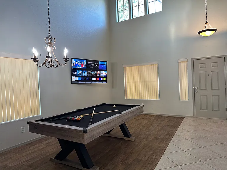 Pool Table with 65" Smart TV in Game Room Area.