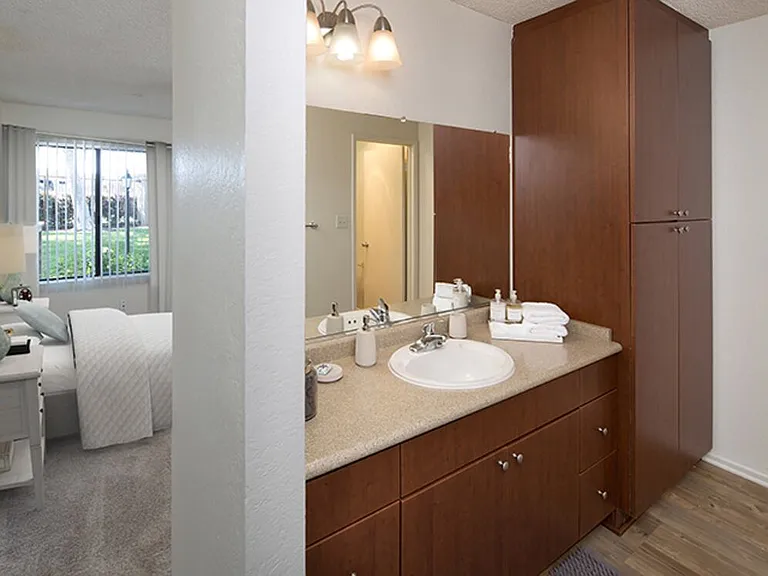 Classic Package II bath with dark cherry cabinetry, beige laminate countertop, and hard surface flooring