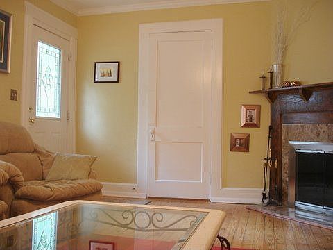 Living room with working masonry fireplace and enough wall space for a 62" TV.