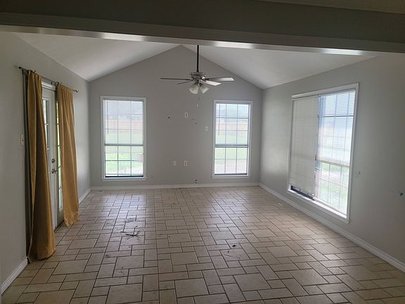 Large living area with cathedral ceiling french doors leading to back porch