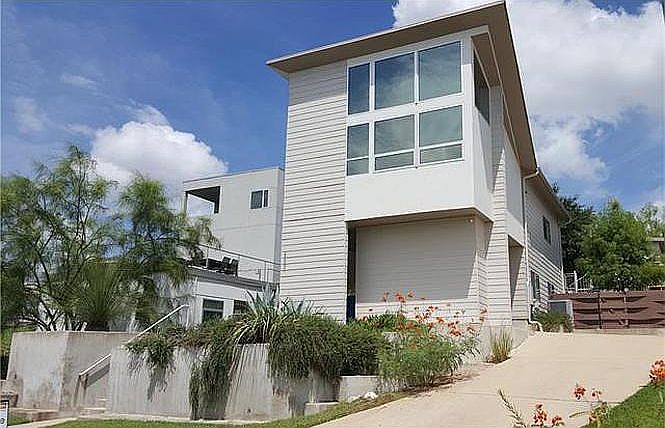 Front exterior from street - includes driveway parking and enclosed carport. Plenty of storage in carport.