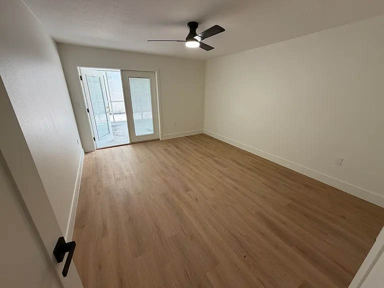 Guest bedroom with private screened covered porch to backyard