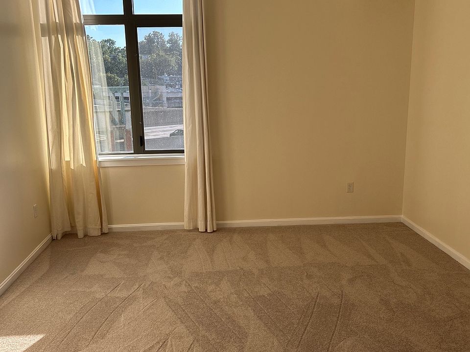 Primary Bedroom with new carpet, new ceiling fan, large walk in closet, separate shower and tub.