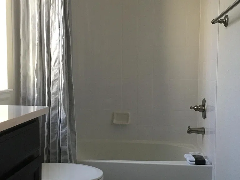 Tub/shower view of shared bathroom upstairs
