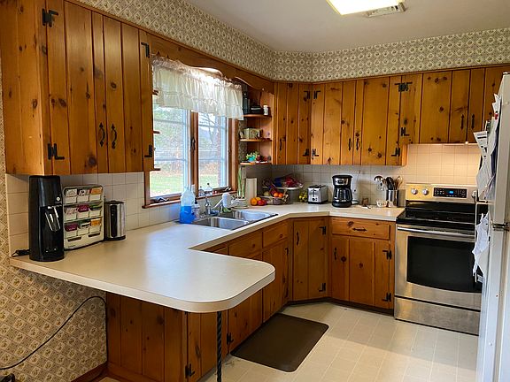 Eat-in kitchen has plenty of cabinets, newer oven and large fridge.