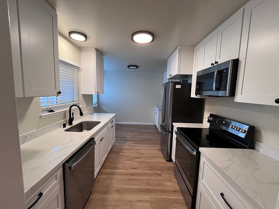 Kitchen with marble countertops and updated appliances