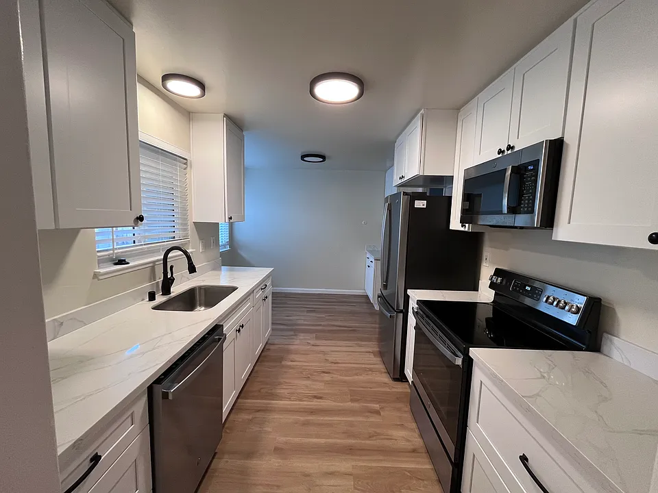 Kitchen with marble countertops and updated appliances