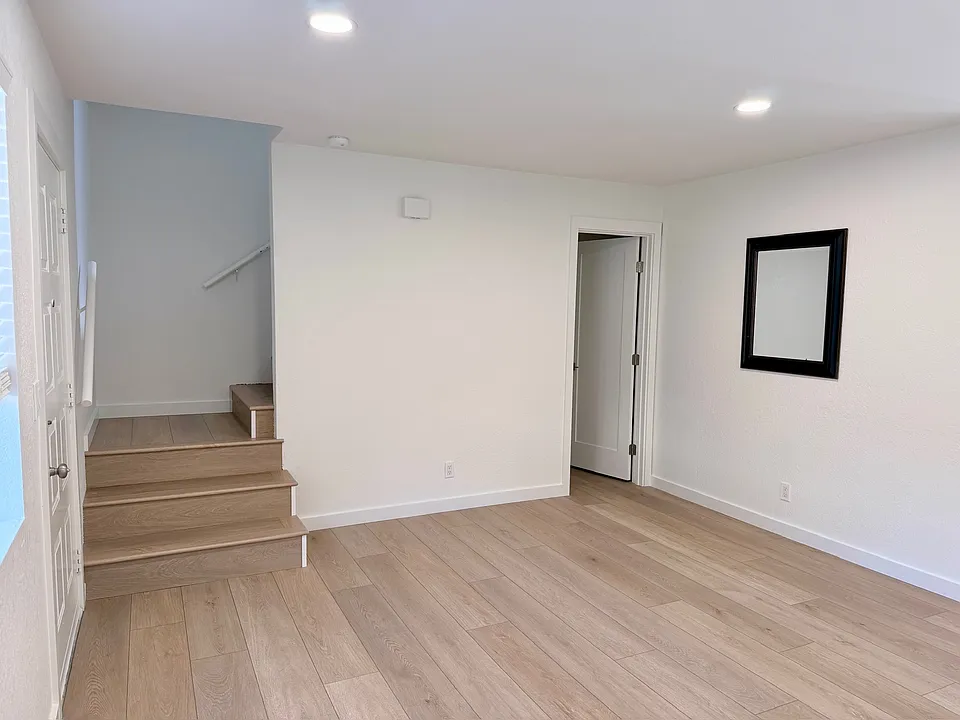 family room looking at stairs and 1/2 bath