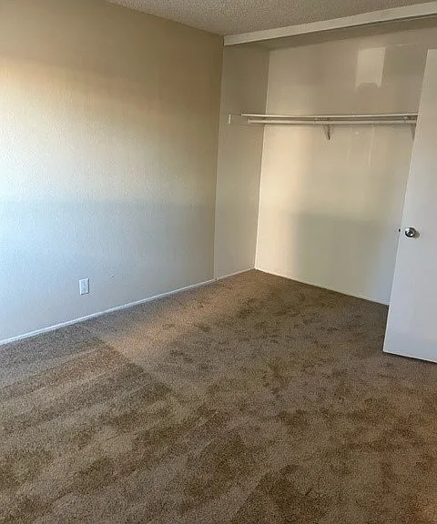 Spacious bedroom with large closet at Mission Bell Apartmentss.