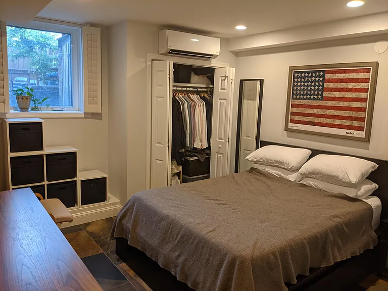 bedroom with large and bright window, plenty of space for a queen bed, a desk, dresser + closet