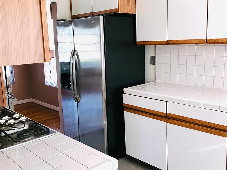 updated kitchen with newer stainless steel style refrigerator
