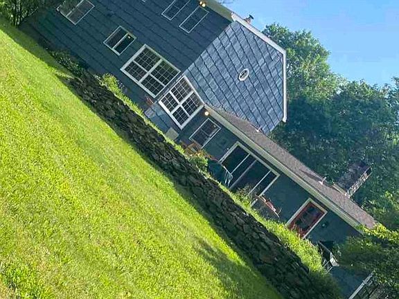 Back of house looking up from the stream