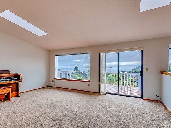 Living room area with access to the large front deck.  