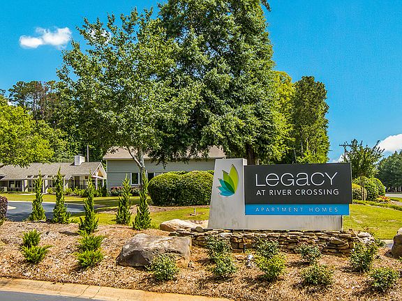 Entrance to Legacy at River Crossing surrounded by green trees in Macon, GA