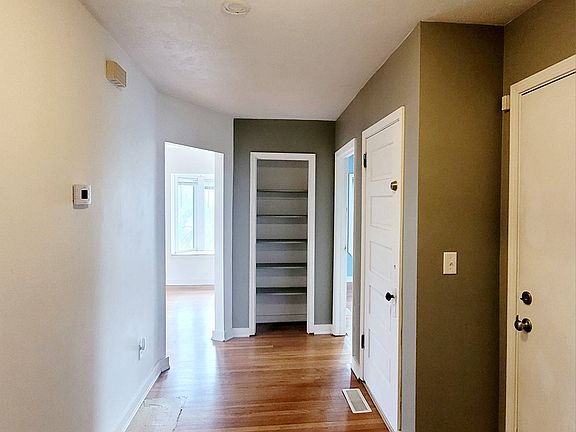 Living area hallway landing with storage closet