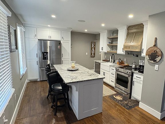 Recently renovated luxury Kitchen with Island, high end appliances, and floor to ceiling pantry cabinets.