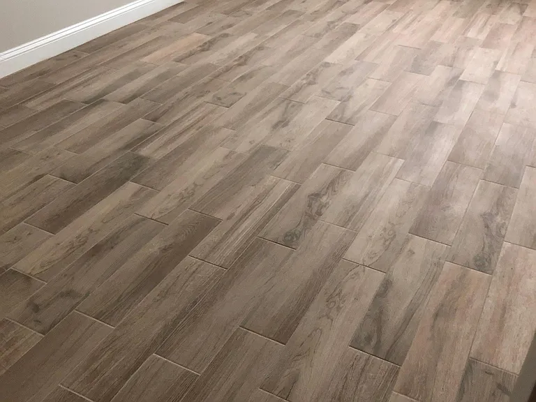Wood look tile recently replaced all carpet in all 3 bedrooms. Color is lighter than this photo. Beige, cream, grey undertones.