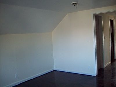 One of 3 upstairs bedrooms. Floors have been refinished.