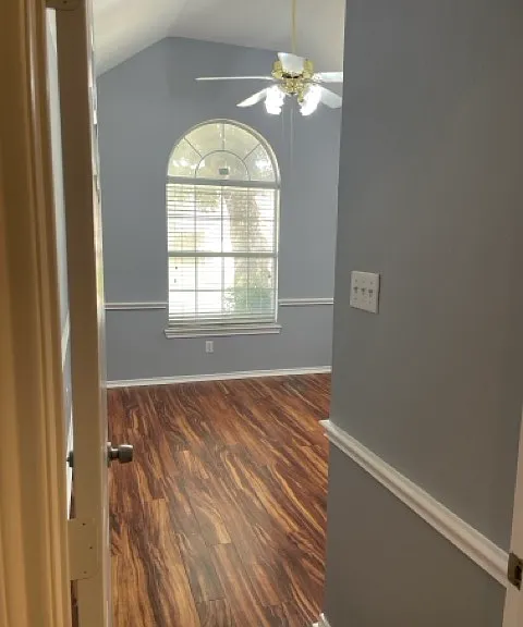 1st bedroom, ceiling fan, vaulted ceiling, window faces front of house.
