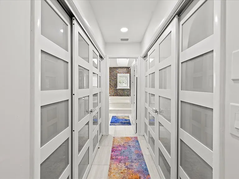 Large walk-in closet to the left. Customized shelving in each closet.